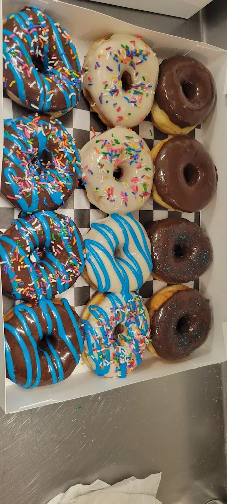 Box of a dozen frosted and sprinkled donuts from a bakery in Lead, SD